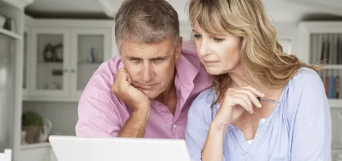 Couple researching rvs on laptop